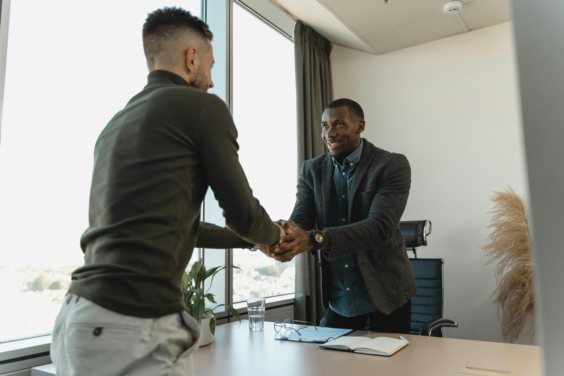 2 Men shaking hands Signaling business deal 